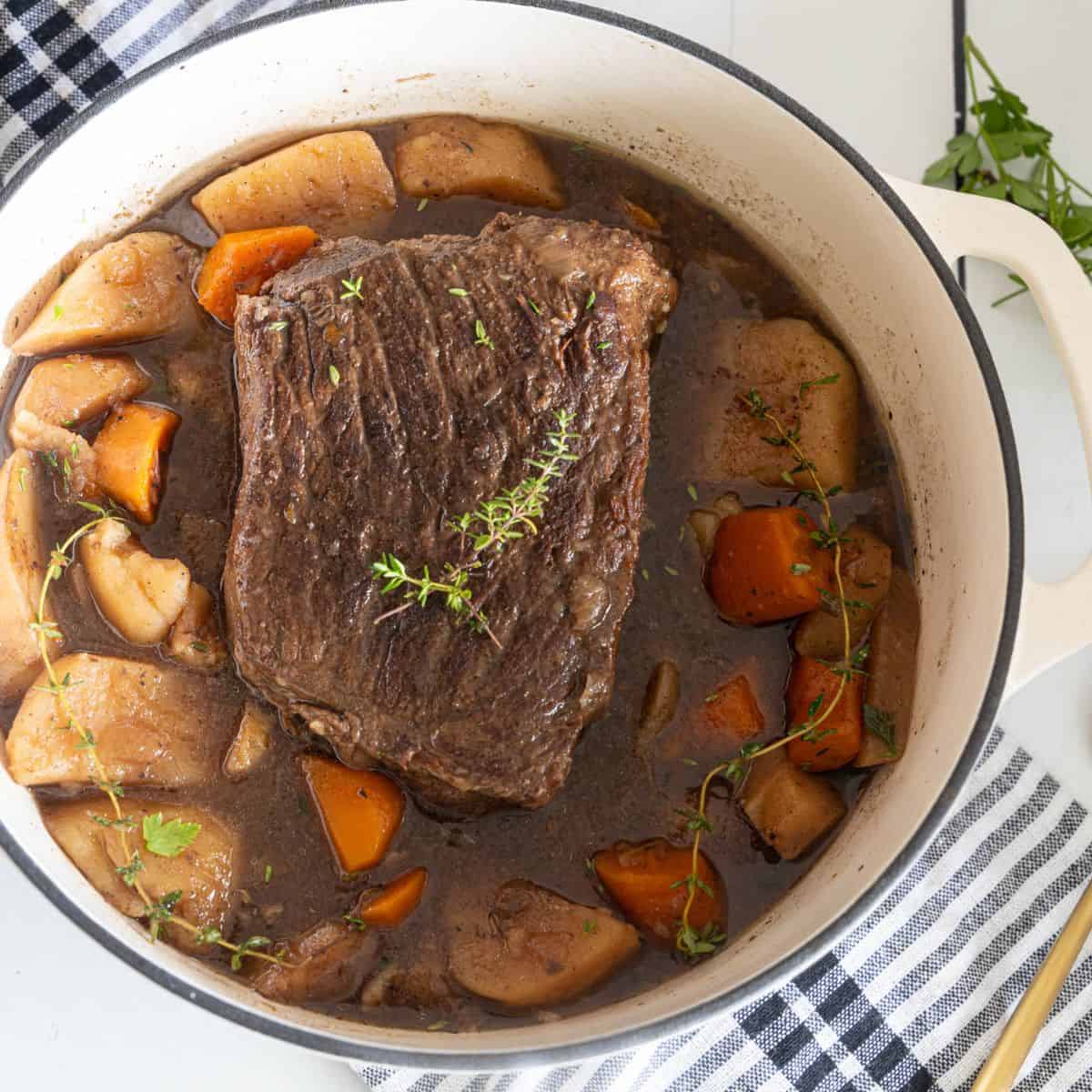 An overhead view of red wine braised pot roast and vegetables.