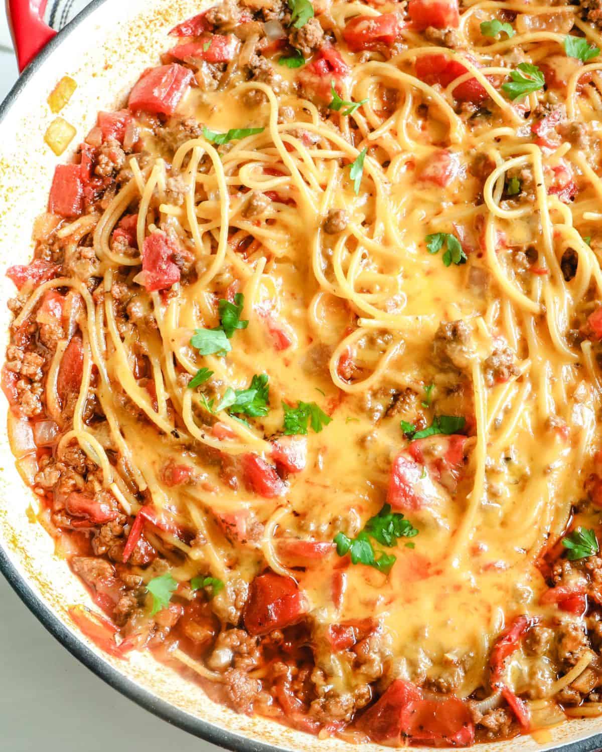 An overhead view of taco spaghetti on a skillet. 