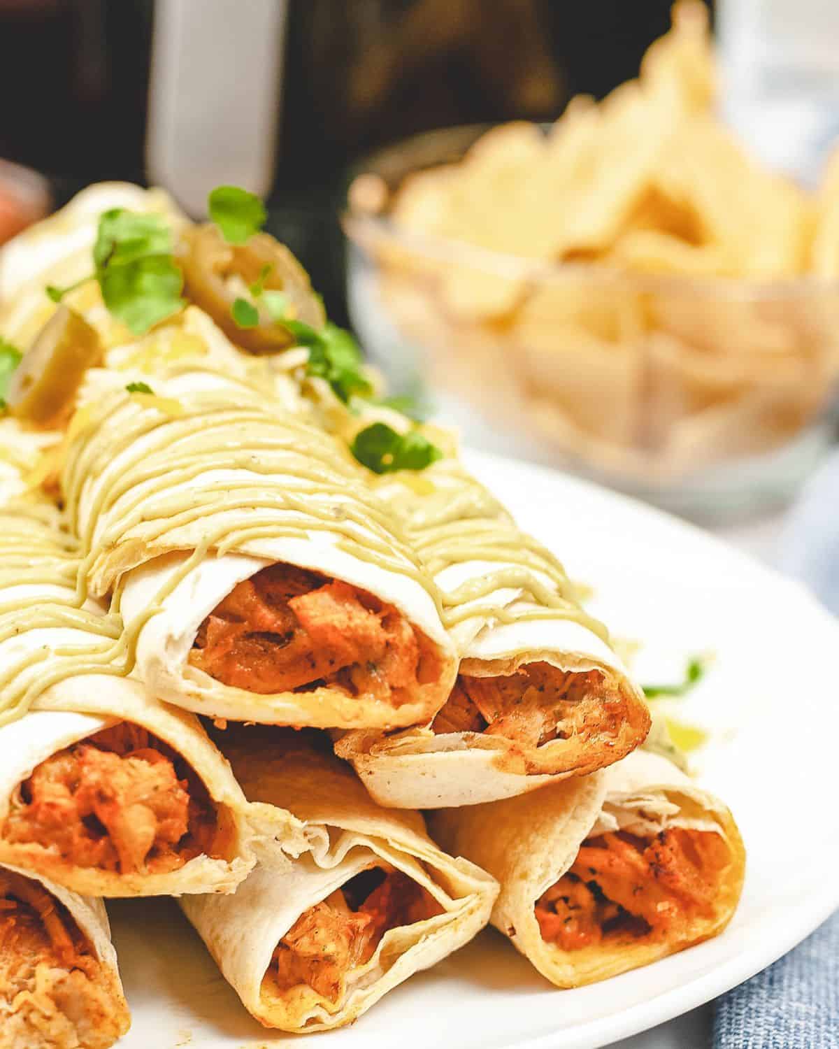 Air fryer chicken taquitos on a platter.