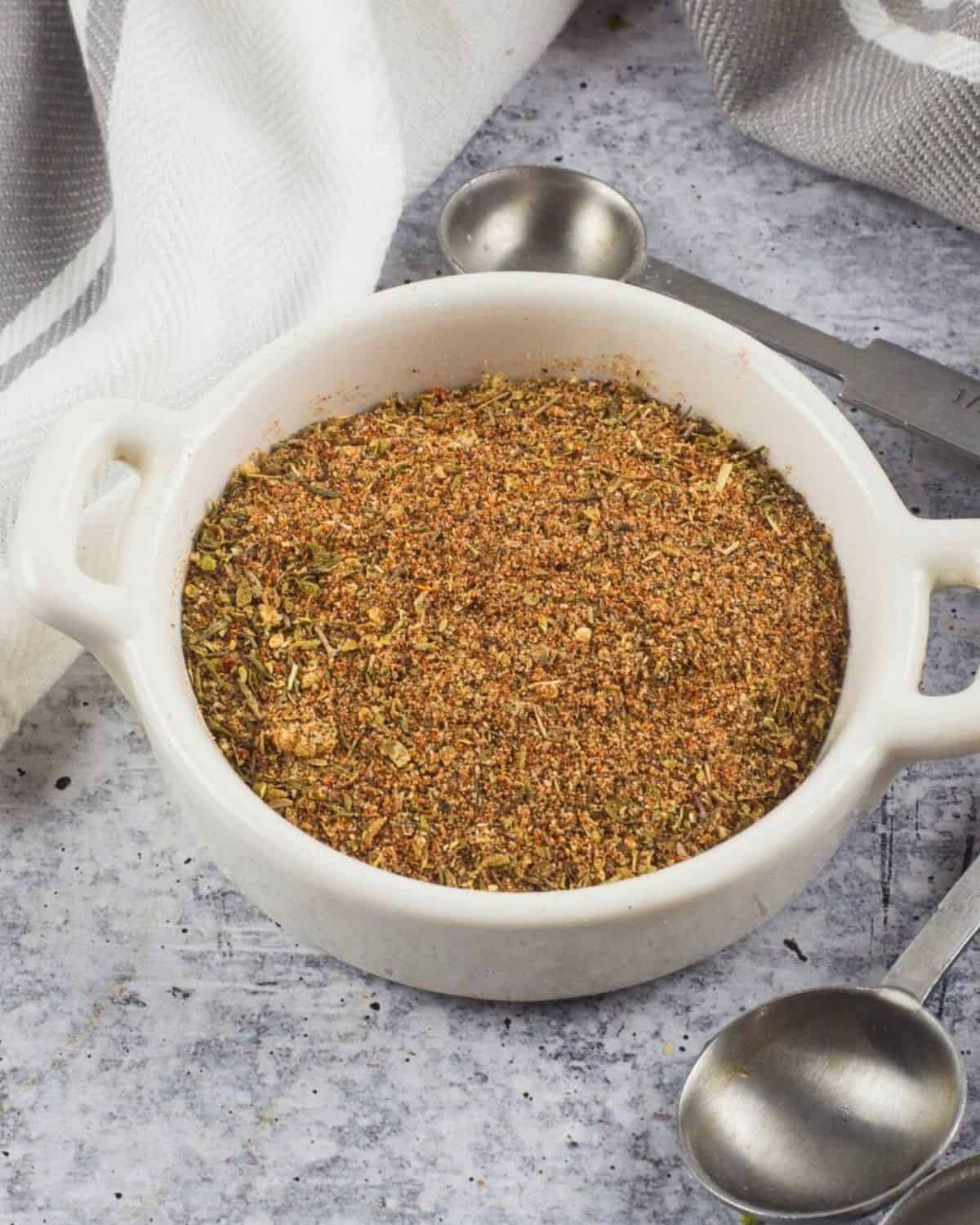 Homemade Cajun seasoning in a white small bowl.