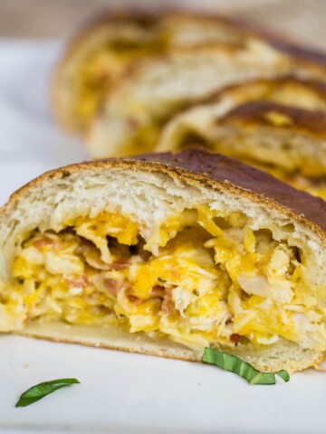 bacon chicken ranch Stromboli sliced on a plate.