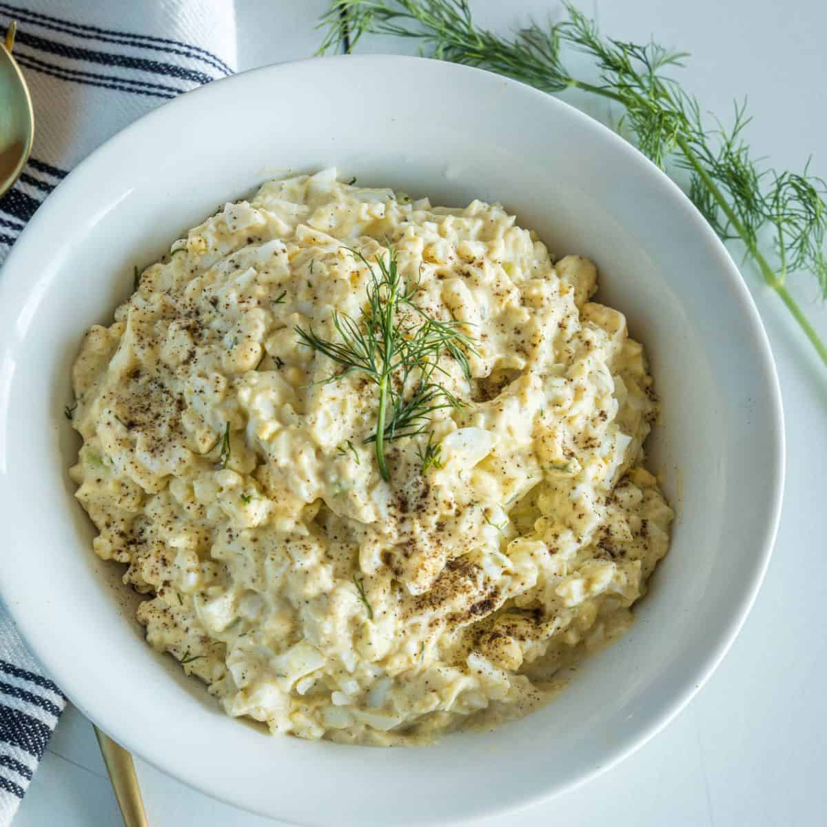 An overhead view of egg salad in a bowl.