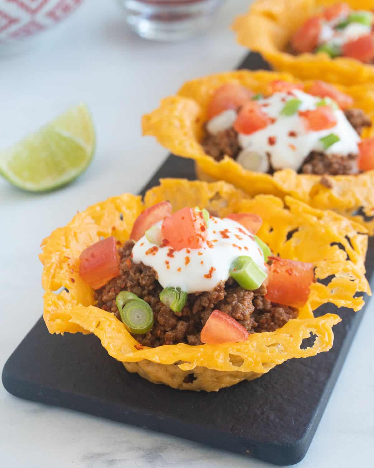 Keto cheese crisps filled with taco meat, tomatoes, sour cream. 