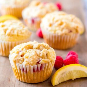 Homemade Raspberry lemon muffins on a wooden table.