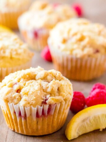Homemade Raspberry lemon muffins on a wooden table.