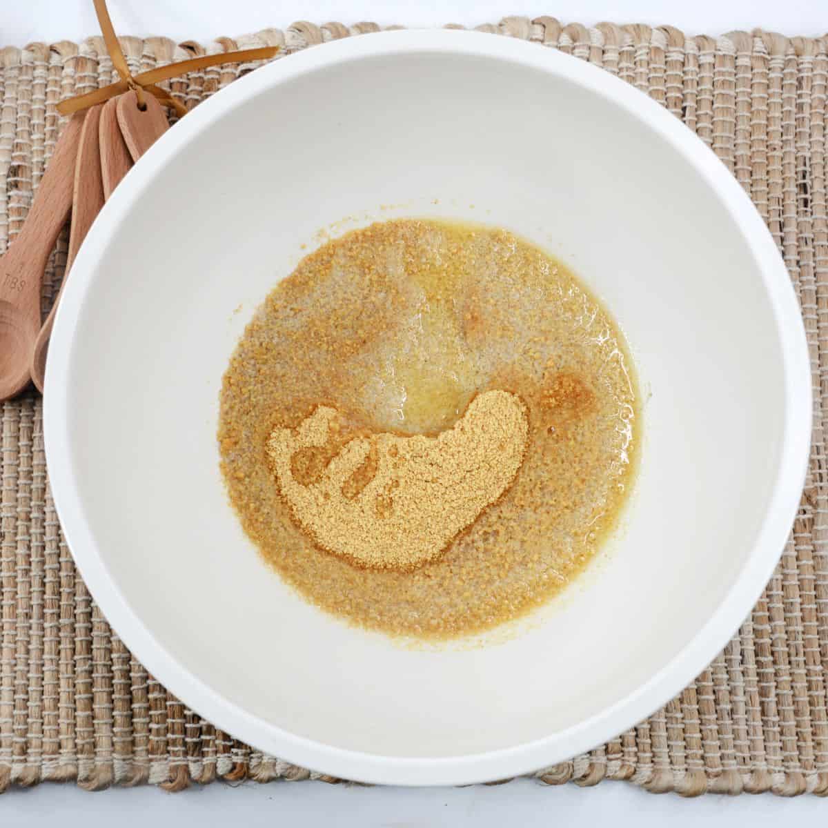 A bowl with graham crackers and butter to make a crust. 