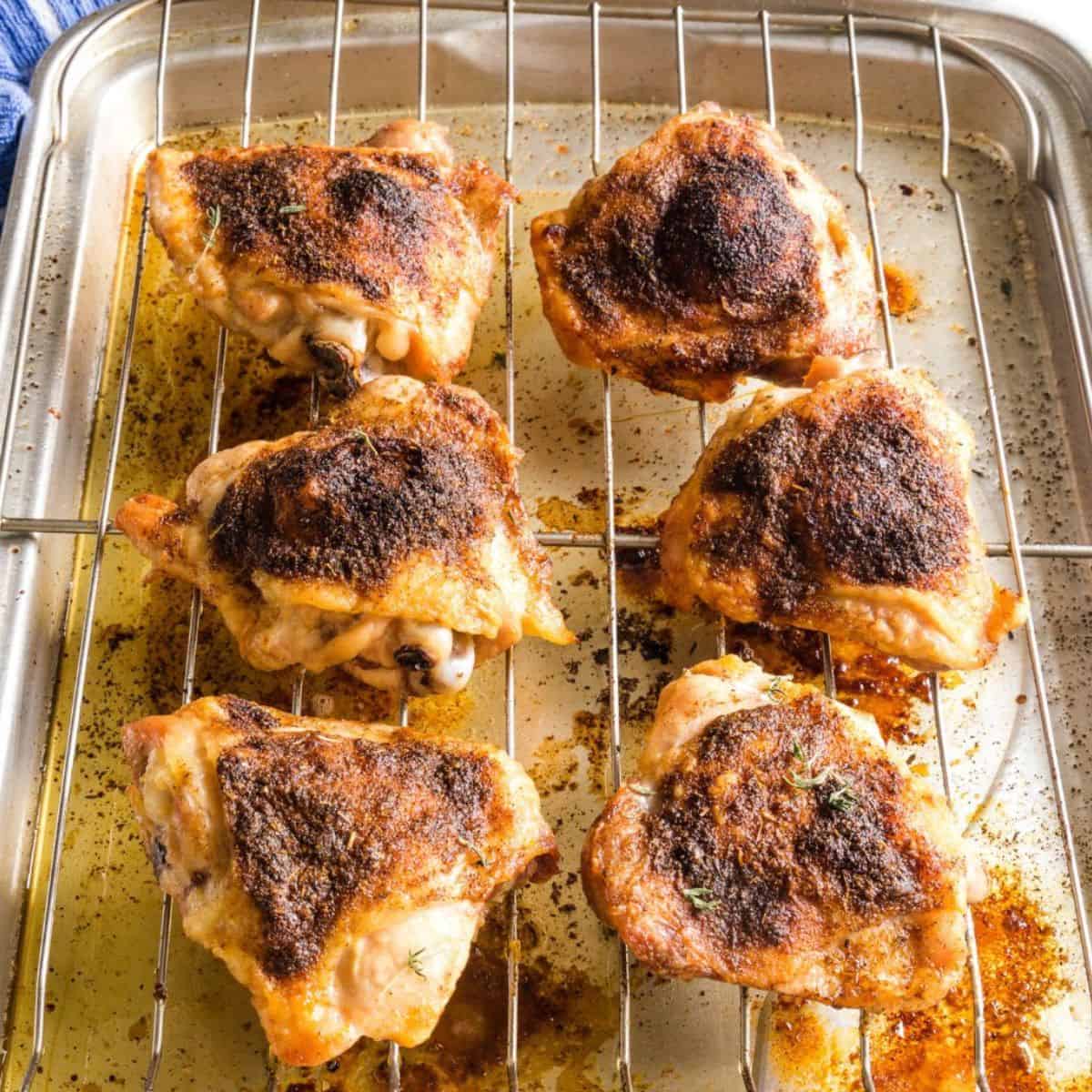 Bone in chicken thighs that have been roasted in the oven on a wire rack.