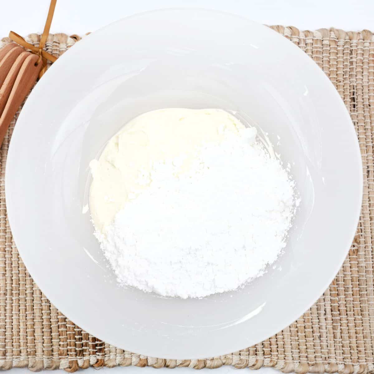 A mixing bowl with crea cheese blended with confectioners' sugar to make white chocolate bars.