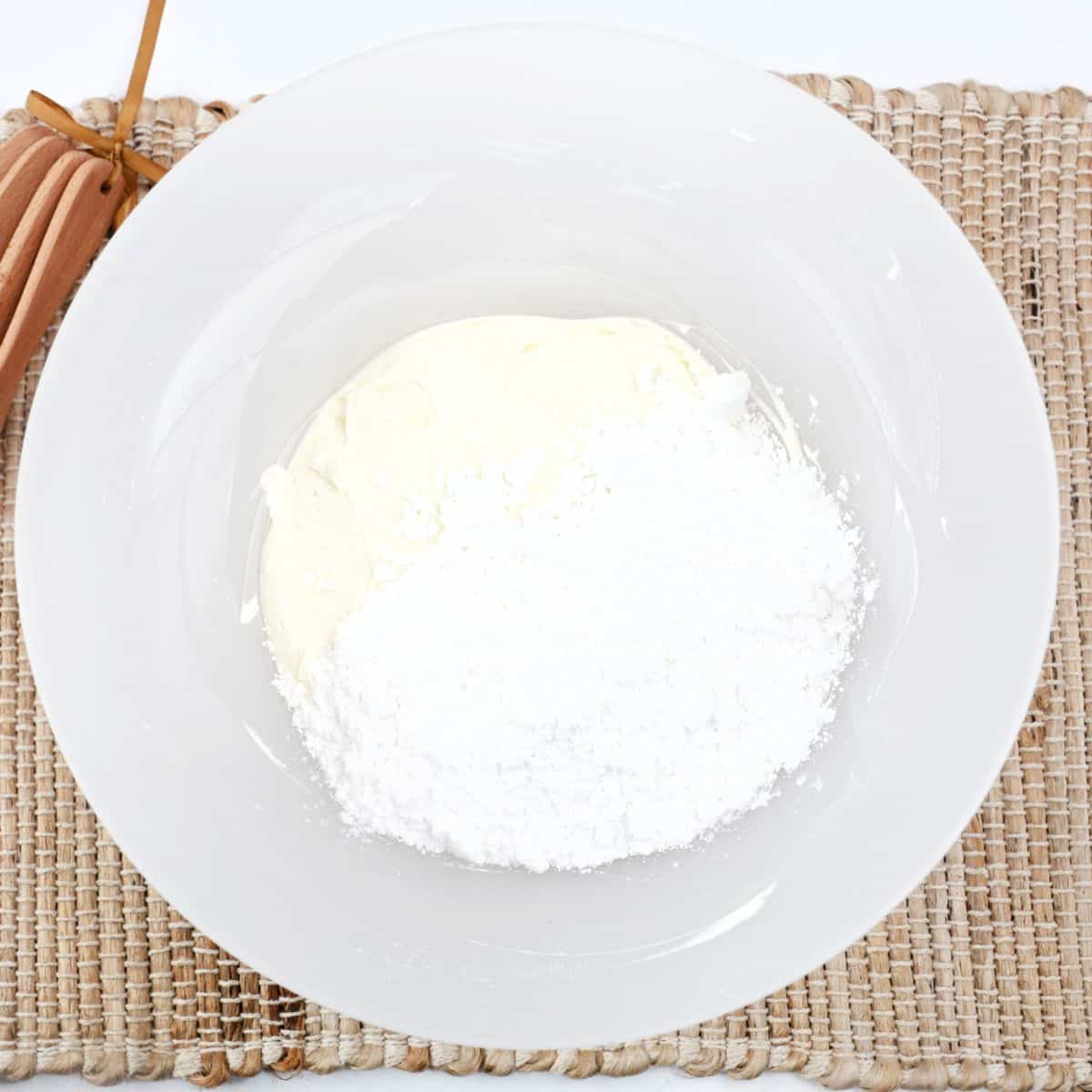 A mixing bowl with crea cheese blended with confectioners' sugar to make white chocolate bars.