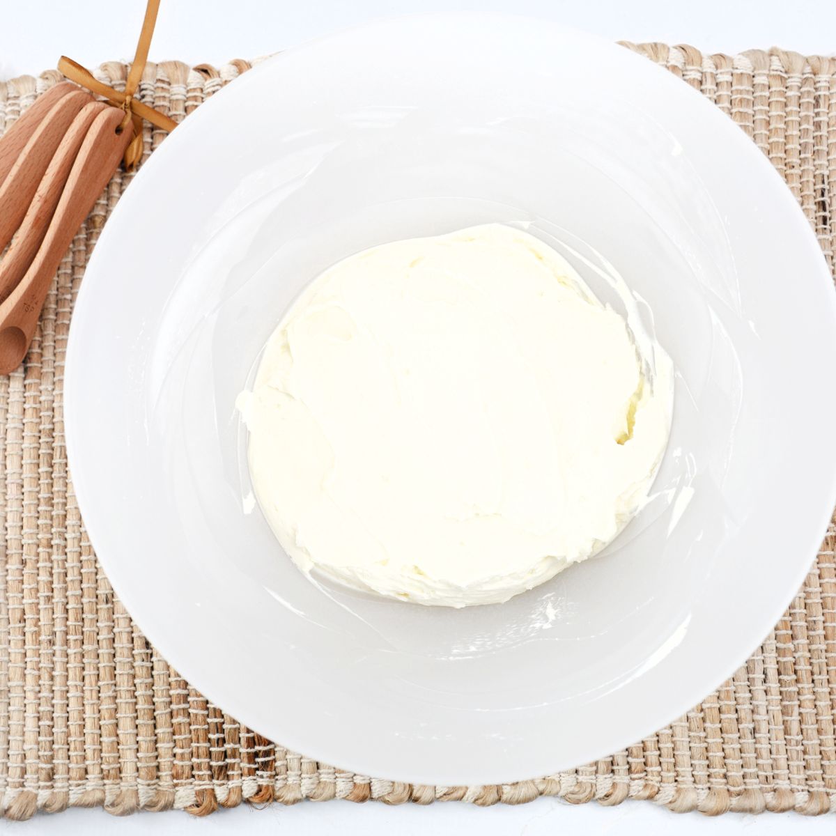 White chocolate cream cheese filling in a bowl for white chocolate raspberry bars.