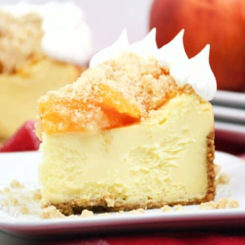 A slice of peach cheesecake with a peach cobbler topping.