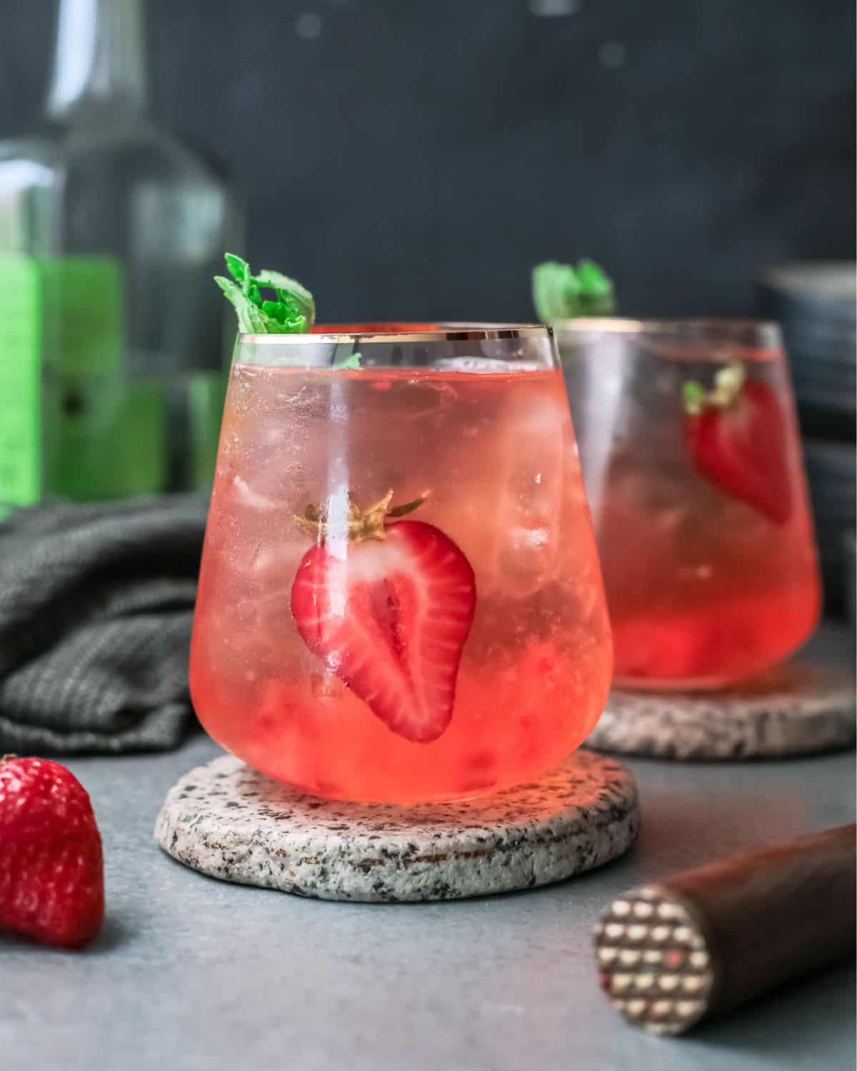 Strawberry Paloma cocktail on a grey counter.