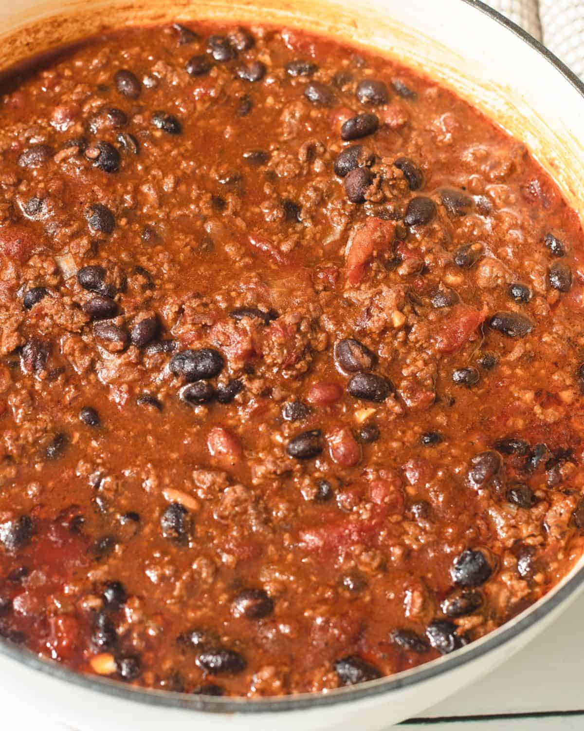 Chipotle chili with chipotle peppers in adobo sauce, black beans, ground beef in a red chili.