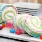 A pastel colored cake roll with a cream cheese filling.