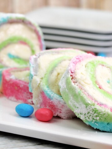 A pastel colored cake roll with a cream cheese filling.
