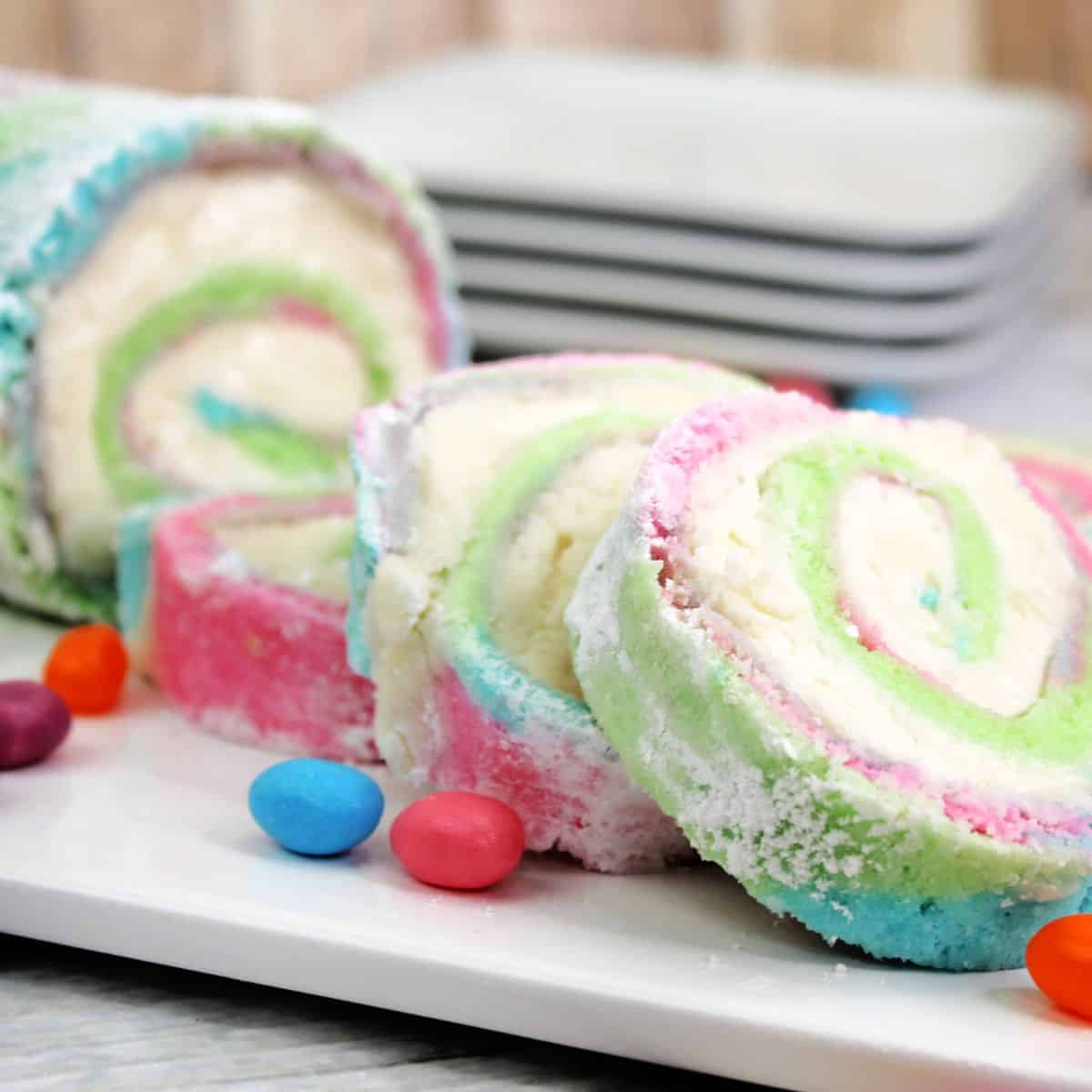 A pastel colored cake roll with a cream cheese filling.