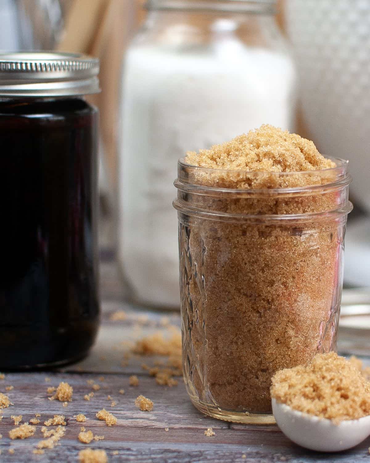 Mason jars filled with sugar, molasses, and homemade brown sugar. 