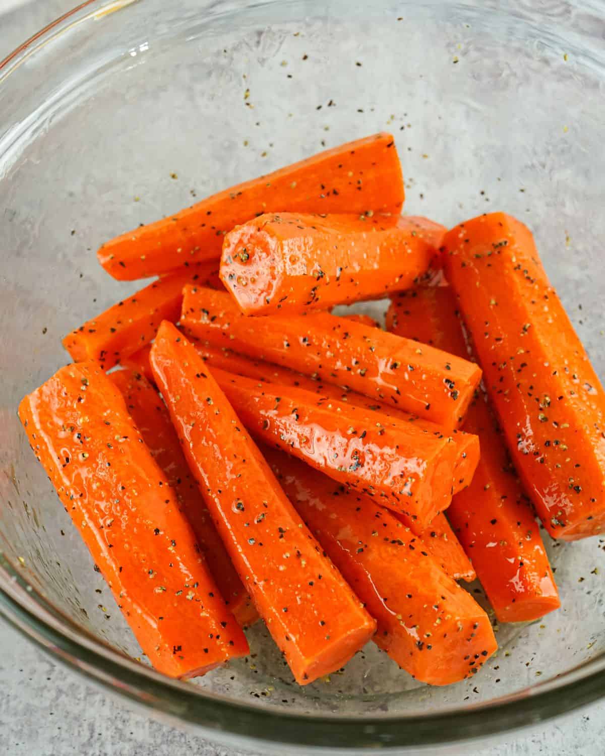 Carrots seasoned with salt, black pepper, and olive oil.