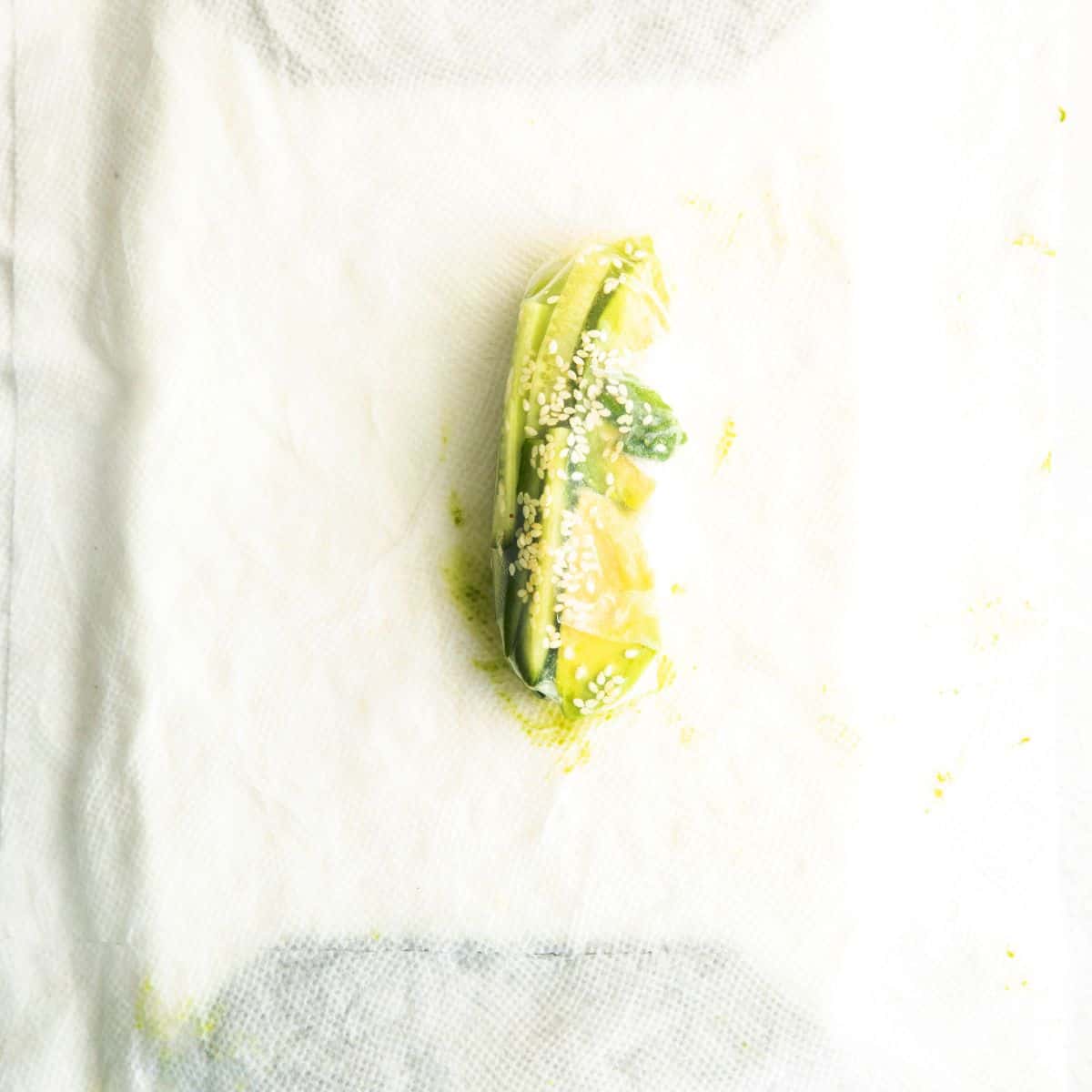 Rice paper filled with avocado and rice noodles to make spring rolls.
