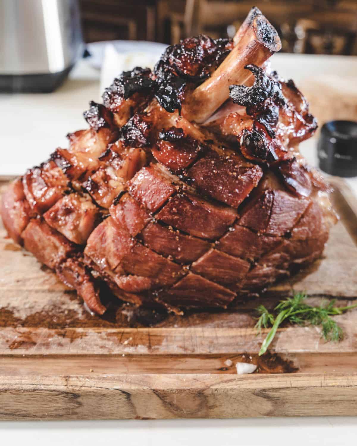 A scored honey glazed ham.