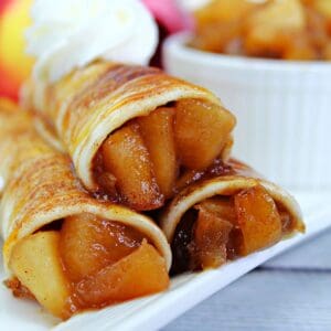 A stack of Mexican tortillas stuffed with apple pie filling to make apple pie taquitos.