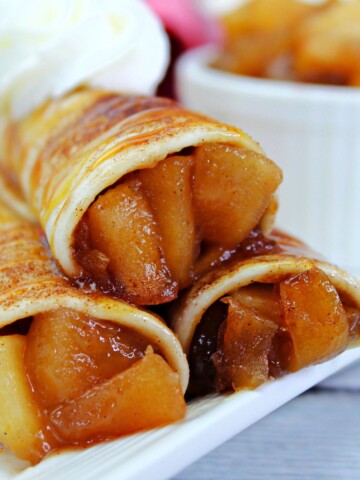 A stack of Mexican tortillas stuffed with apple pie filling to make apple pie taquitos.