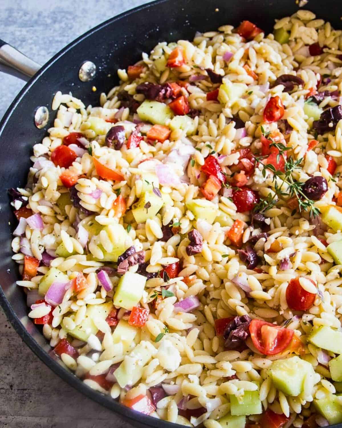 Mediterranean orzo salad with olives, feta cheese, and peppers with a Greek vinaigrette.