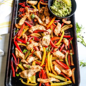 One pan fajitas made with chicken on a sheet pan.