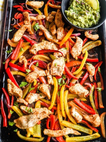 One pan fajitas made with chicken on a sheet pan.