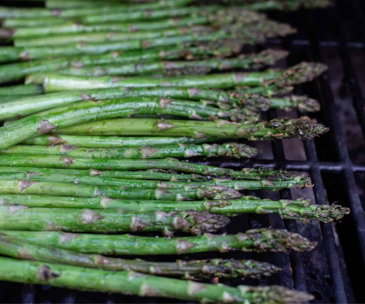 Grilled asparagus on the grill with olive oil, salt, and black pepper.