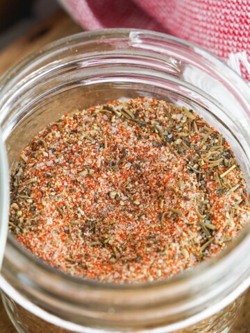 A glass mason jar filled with a steak seasoning rub made from scratch.