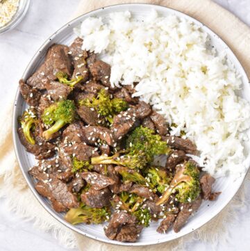 An overhead view of Chinese beef and broccoli served with rice.