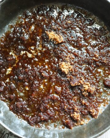 A brown sugar layer for an upside down cake in a cast iron pan.