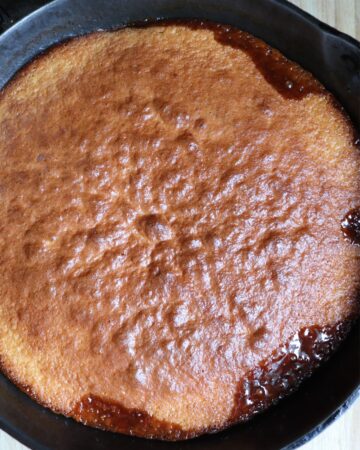A cast iron cake with pineapples and cherries.