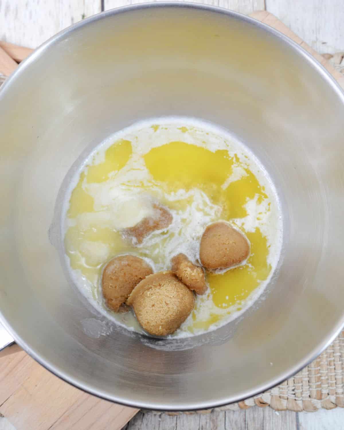 A stainless steel bowl with eggs and sugar to make turtle cookies.