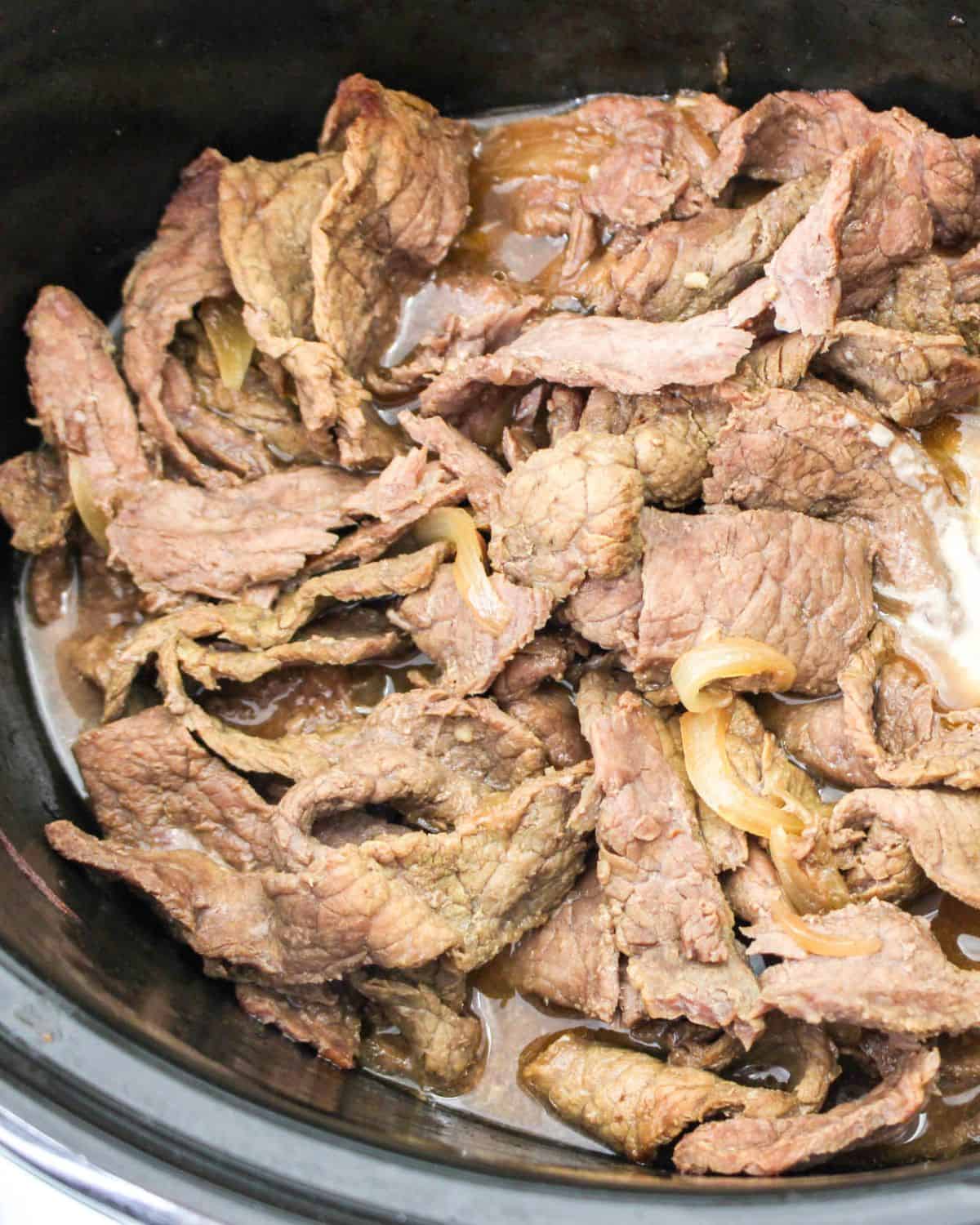 Process shot of Korean beef in the slow cooker.