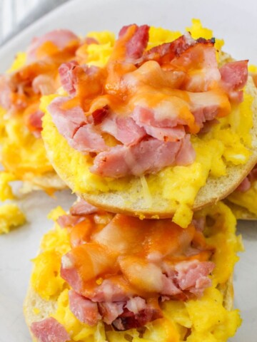 Mini bagels with scrambled eggs, diced ham, and cheese.