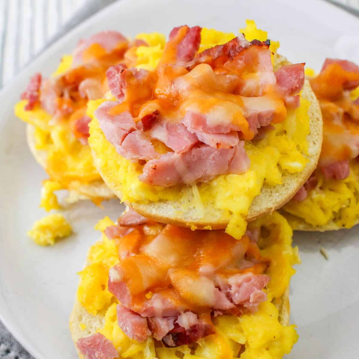 Mini bagels with scrambled eggs, diced ham, and cheese.