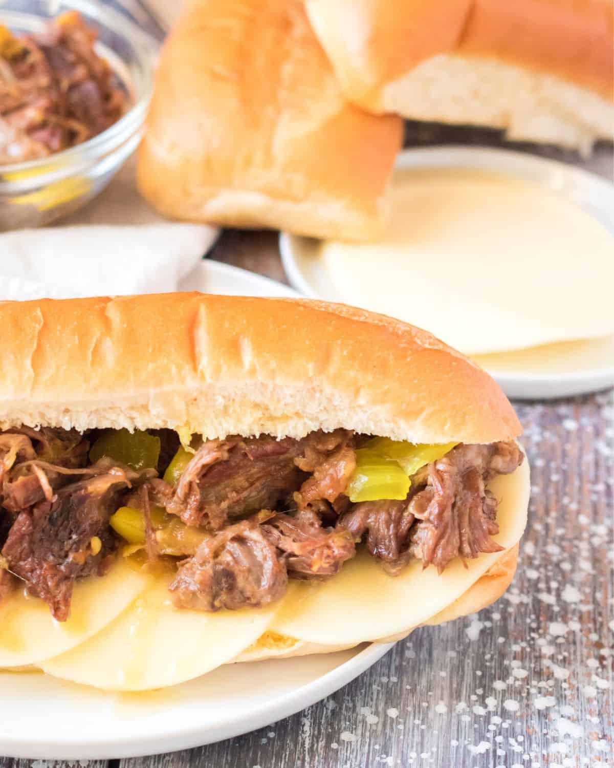 Assembling an Italian beef sandwich made in the slow cooker.