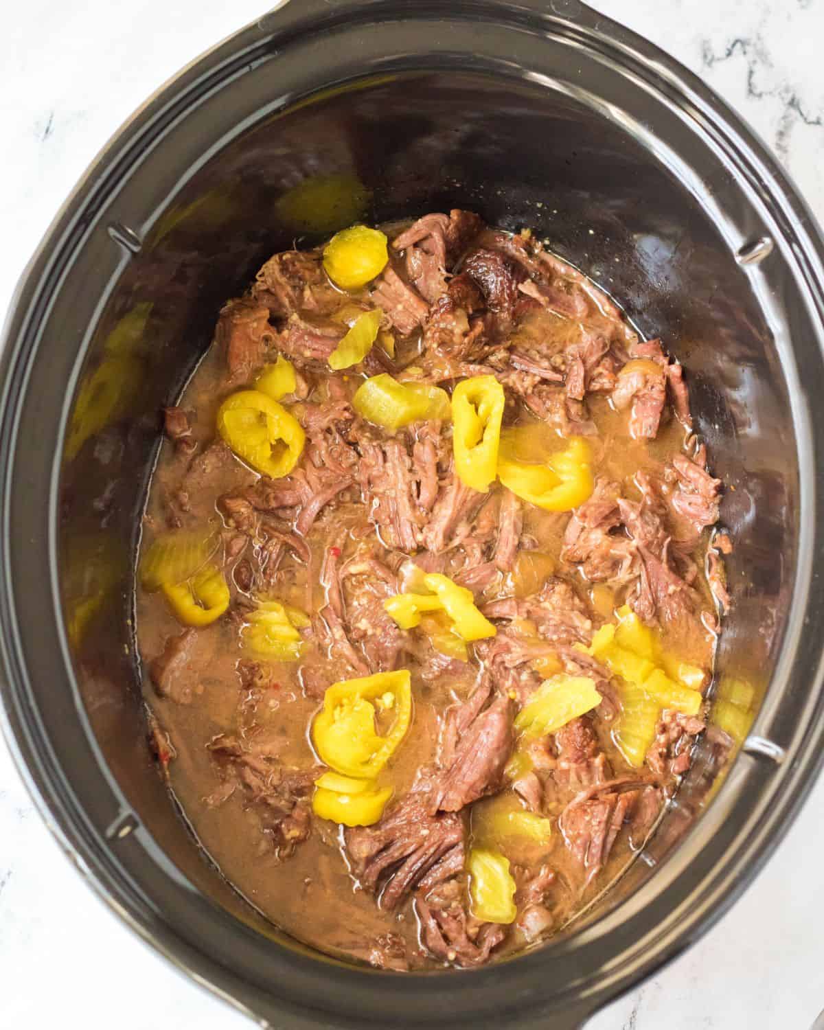 Slow cooker Italian beef with Italian peppercorn peppers.