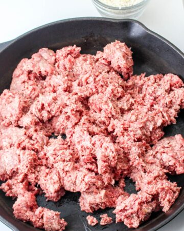 Ground beef in a large pan being browned for cabbage roll casserole. 