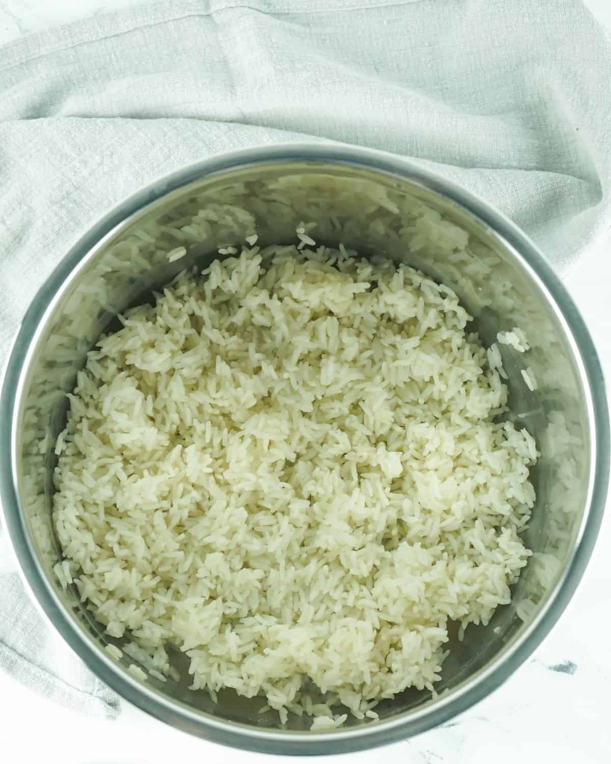 An Instant Pot vessel with cooked white rice.