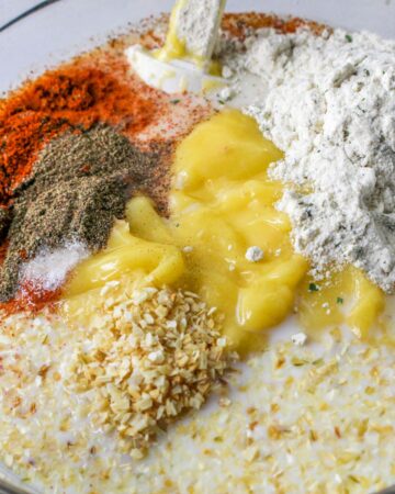 A bowl of cream of chicken soup and ingredients to top chicken and potatoes.