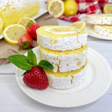Lemon roll cake made with cake mix and rolled in confectionary sugar for a delicious lemon dessert.