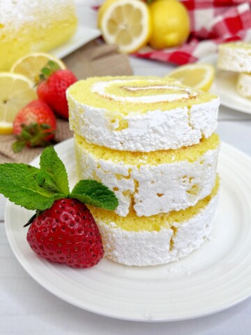 Lemon roll cake made with cake mix and rolled in confectionary sugar for a delicious lemon dessert.