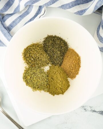 A mix of spices in a bowl to make poultry seasoning.