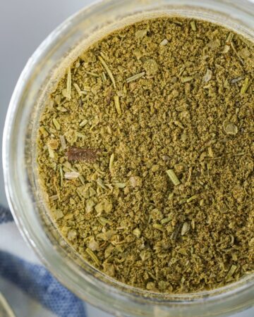 Homemade Poultry Seasoning in a glass mason jar.
