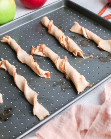 Puff pastry dough twisted and filled with apple pie filling.