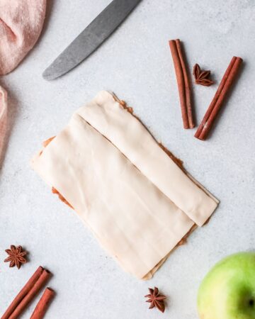 Puff pastry being cut to make puff pastry twists.