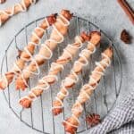 Apple puff pastry twists on a wire rack.